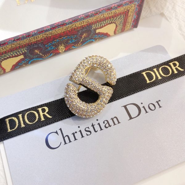 DIOR CD BROOCH GOLD WITH STONES ATTACHED