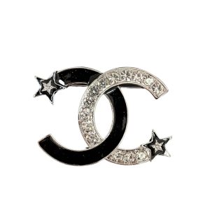 CHANEL CC BROOCH SILVER AND BLACK WITH TWO SMALL STARS